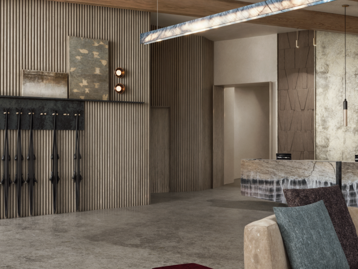 The image shows a modern, stylish lobby with a marble reception desk, decorative lighting, textured walls, and plush seating.